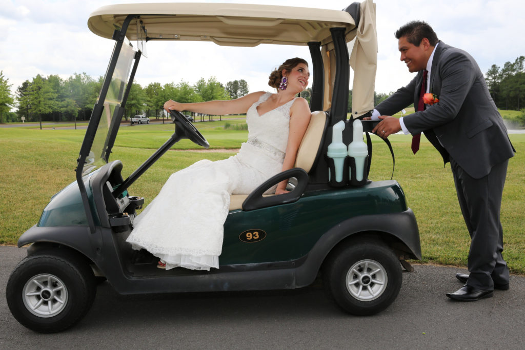 bride and groom in golf cart