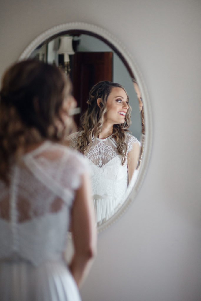 bride posing in fron of the mirror at east lynn farm inn