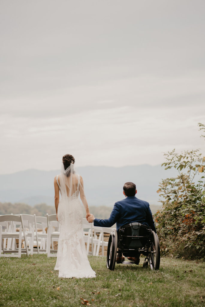 bride and groom holding hands at blue mountain lodge facin the Shenandoah valley