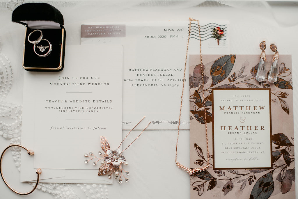 bridal details with invitation, bride accesories and wedding bands