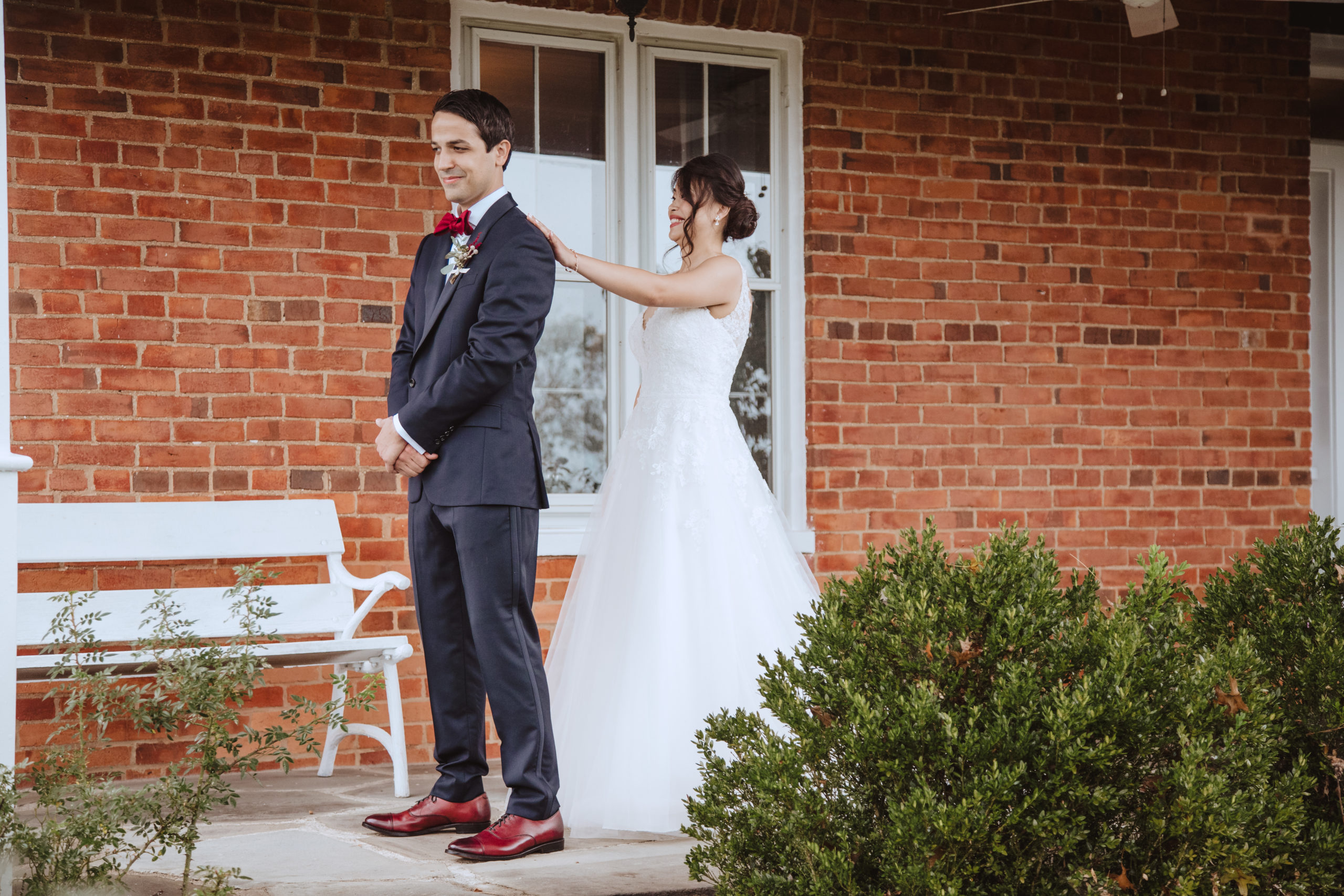 First Look Bride and Groom in farmhouse porch