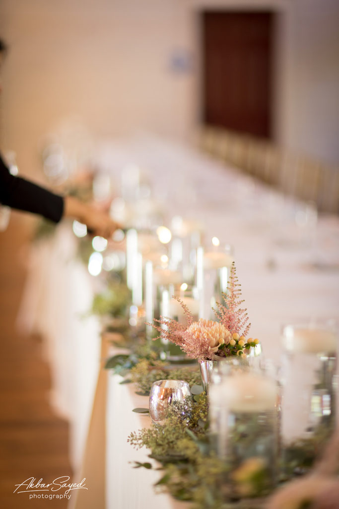 The long head table or king table, with candles and flowers.