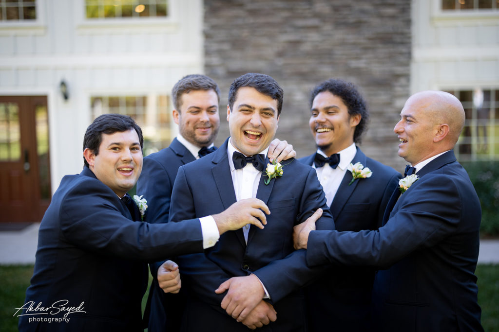 The groom with the best men smiling, after the ceremony.