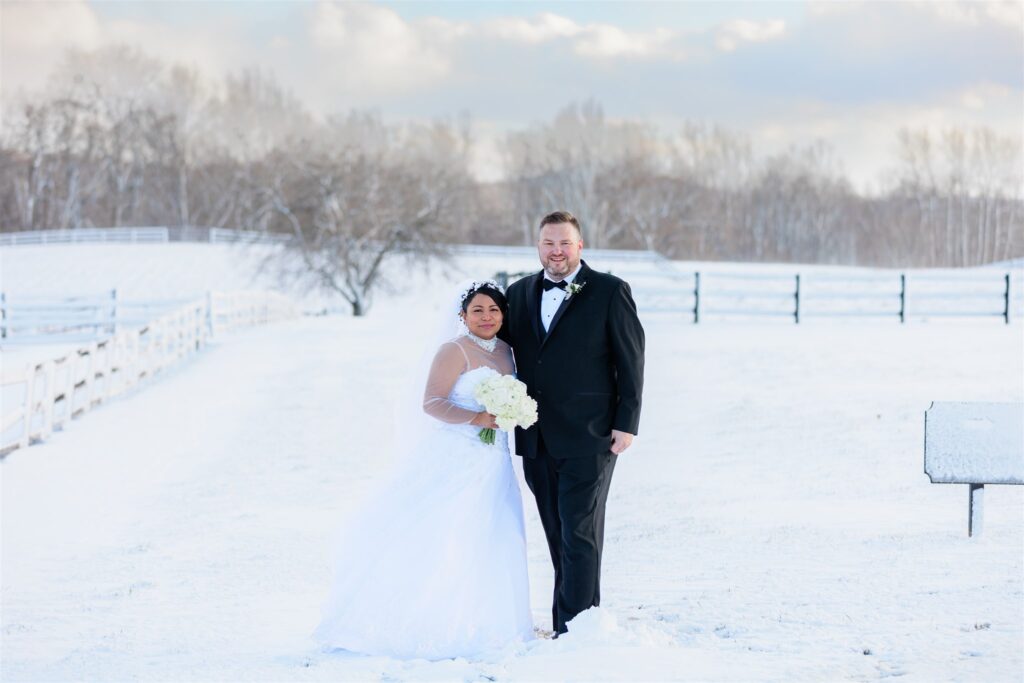 Bride and groom at the Middleburg barn outside in a snow day